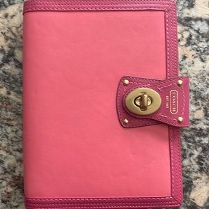 Super cute Coach medium size business planner. Included is a blank address book.